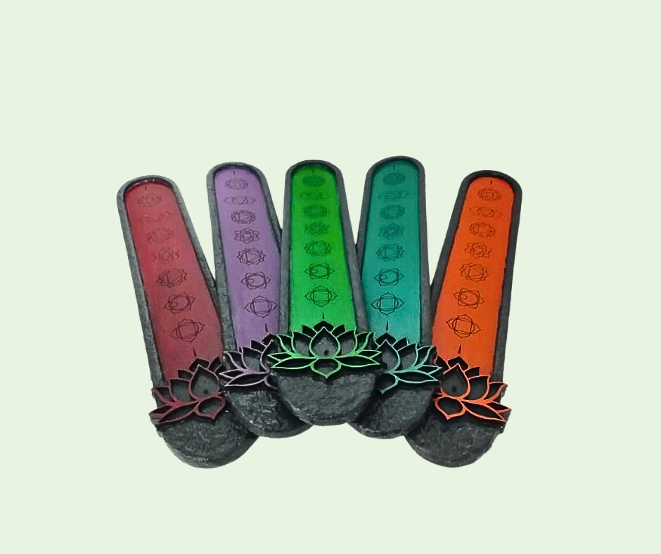 Set of five colorful incense sticks with lotus designs on a light green background