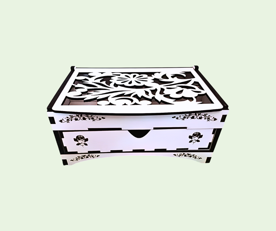 Decorative jewelry box with intricate cut-out patterns on a light green background